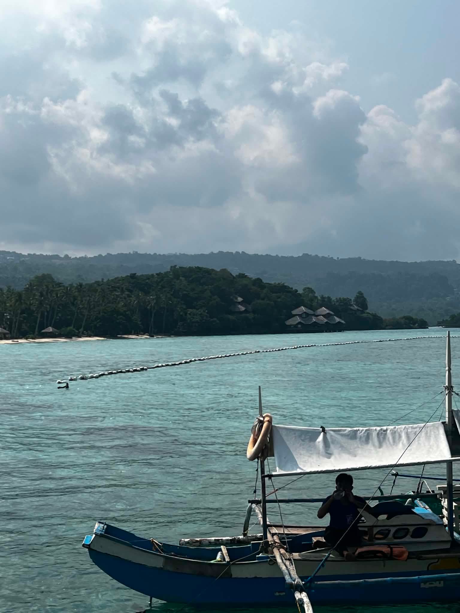 Coastal boats and tropical island shoreline